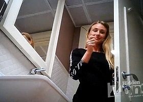 За девушкой подглядывают в публичном туалете